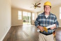 Contractor With Plans in Hard Hat In Empty Room with New Woodwood Floors Royalty Free Stock Photo