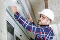 contractor removing plastic from window facia board Royalty Free Stock Photo