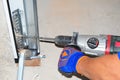 Contractor repair and install garage door with drilling machine. Replace a Broken Garage Door Spring.