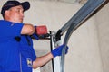 Contractor repair and install garage door. Replace a Broken Garage Door Spring Royalty Free Stock Photo