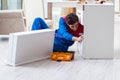 Contractor repairman assembling furniture under woman supervisio Royalty Free Stock Photo