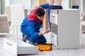 Contractor repairman assembling furniture under woman supervisio Royalty Free Stock Photo