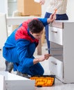 Contractor repairman assembling furniture under woman supervisio Royalty Free Stock Photo