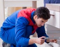 Contractor repairman assembling furniture under woman supervisio Royalty Free Stock Photo