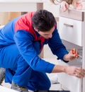 Contractor repairman assembling furniture under woman supervisio Royalty Free Stock Photo