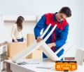 Contractor repairman assembling furniture under woman supervisio Royalty Free Stock Photo