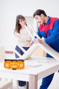 Contractor repairman assembling furniture under woman supervisio