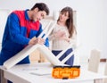 Contractor repairman assembling furniture under woman supervisio
