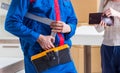 Contractor repairman assembling furniture under woman supervisio Royalty Free Stock Photo