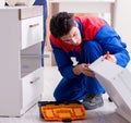 Contractor repairman assembling furniture under woman supervisio Royalty Free Stock Photo