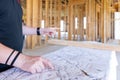 Contractor reviews plans for new construction Royalty Free Stock Photo