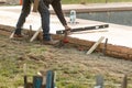 Contractor Smoothing Freshly Poured Cement