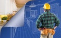 Contractor Standing In Front Custom Kitchen Blueprint Drawing With Page Corner Curling To Reveal Finished Construction