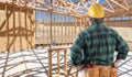 Contractor Standing Inside Construction Framing of New House. Royalty Free Stock Photo