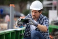 contractor taking photograph with smartphone on building site