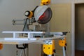 Miter Saw on a construction site with a worker in contractor uses a circular saw to cut and trim Royalty Free Stock Photo
