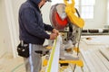 Contractor Using Circular Saw Cutting Crown Moulding for Renovation.