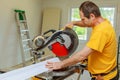 Contractor Using Circular Saw Cutting Crown Moulding for Renovation.