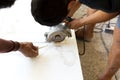 Contractor using circular saw for cutting marble top Royalty Free Stock Photo