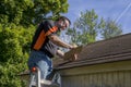 Contractor Using Clipboard To Figure Hail Damage Repair Costs Royalty Free Stock Photo