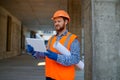 Contractor using digital tablet at construction site