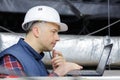 contractor using laptop in roofspace Royalty Free Stock Photo
