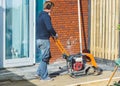 Contractor with a vibratory plate compactor