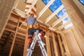 Contractor Worker Inside Newly Built Wooden House Frame Finishing Some Elements