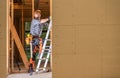 Contractor Worker Inside Newly Built Wooden House Frame