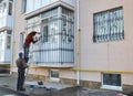 Contractors install window iron security bars