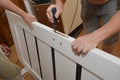 Contractors installing door handle and lock in new white house door