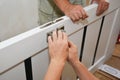 Contractors installing door handle and lock in new white house door