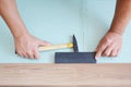 Contractors installing wooden laminate flooring with insulation and soundproofing sheets. Man laying laminate flooring. Man laying Royalty Free Stock Photo