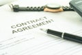 Contracts agreement sign on document paper with black pen.