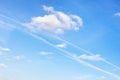 Contrail and fluffy cumuli clouds in blue sky Royalty Free Stock Photo