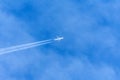 Contrail in the sky higher than clouds left by commercial liner