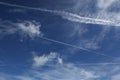 Contrails of air travel, sky with clouds and airpl