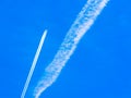 Contrails of aircraft against a blue sky