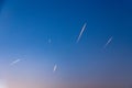 contrails of aircraft in early morning sun at the sky