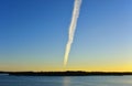 Contrails from airplane in a tranquil sky.