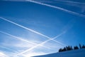 Contrails in the blue sky. Mountain landscape with snow