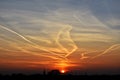 Contrails in the sky at sunset