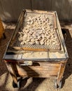 Contraption for roasting Goat. Embers are present in the top shelve with the goat inside the box