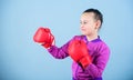 Contrary to stereotype. Boxer child in boxing gloves. Confident teen. Enjoyment from sport. Female boxer. Sport