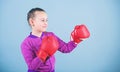 Contrary to stereotype. Boxer child in boxing gloves. Confident teen. Enjoyment from sport. Female boxer. Sport