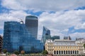 Contrast between modern and ancient buildings on the banks of the River Thames