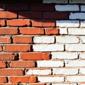 Contrast of old and new bricks on a weathered wall under sunlight Royalty Free Stock Photo