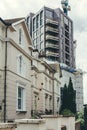 Contrast of an old terraced houses and a new multi-story apartment building in London