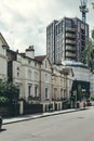 Contrast of an old terraced houses and a new multi-story apartment building in London