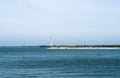 Contrast sea panorama with lighthouse on the pier Royalty Free Stock Photo